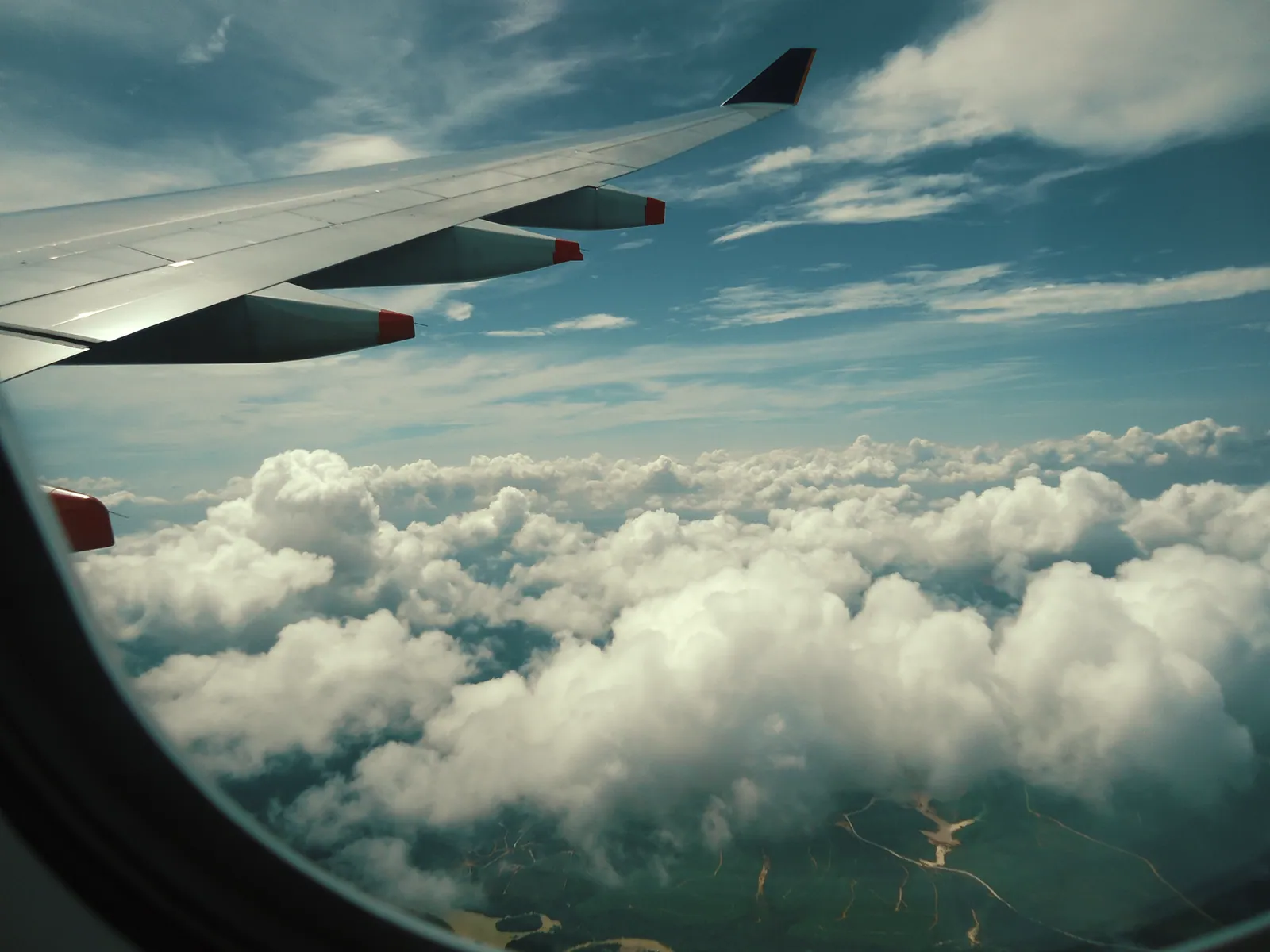An aircraft wing above the clouds